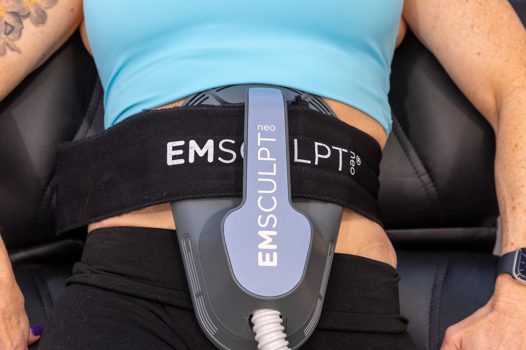 A patient lies on her back as the Shea team administers abdominal Emsculpt NEO near Knoxville.