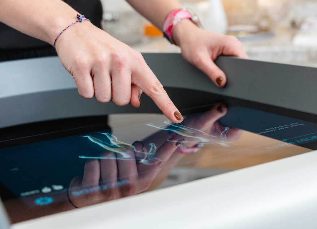 A provider selects a patient's treatment areas on the device for Emsculpt NEO near Farragut.