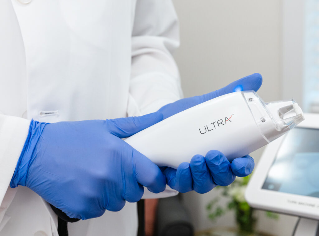 Dr. Bass holds up the laser skin resurfacing device, which is an excellent hyperpigmentation treatment in Oak Ridge.