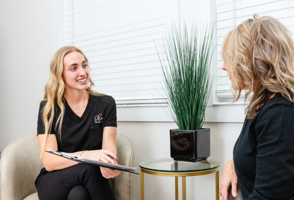 A Shea Aesthetic Clinic provider sits with a patient to teach them about semaglutide in Oak Ridge.